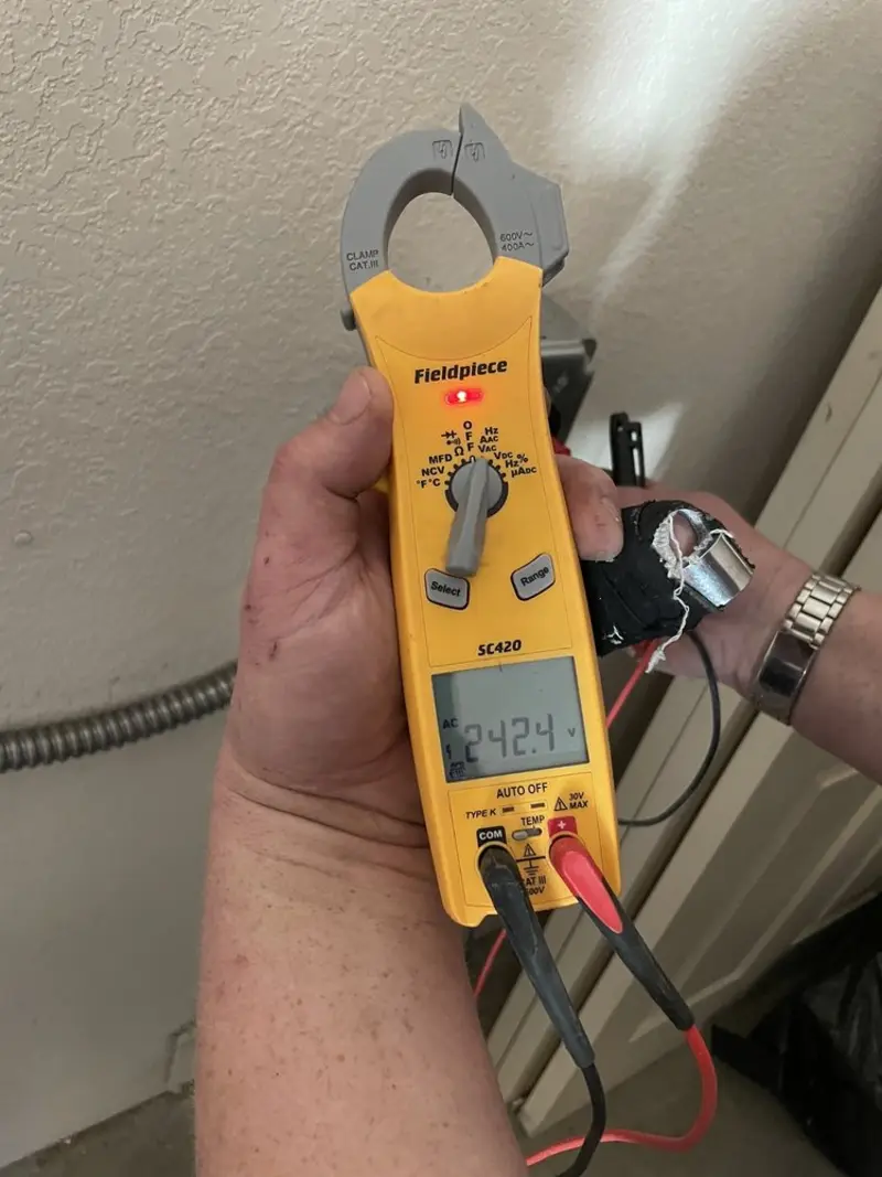 Voltage testing with clamp meter during Outlet Installation in Olney